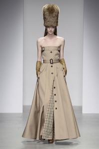 Nude floor length dress with military influences, belted waist and tartan underlay. 